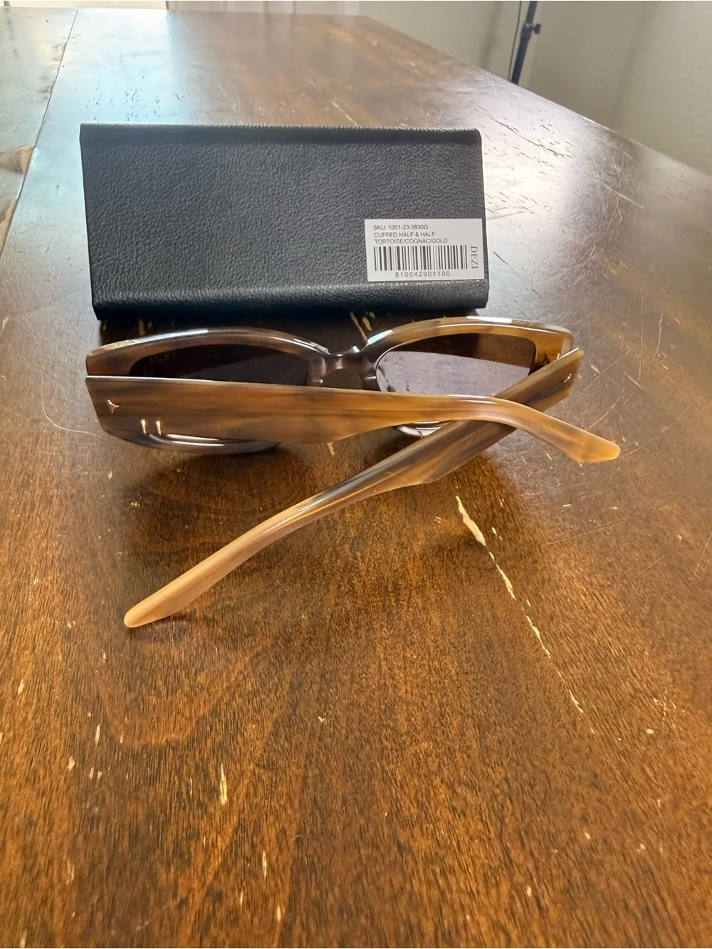 DEZI cuffed square frame sunglasses with asymmetrical piercings.
